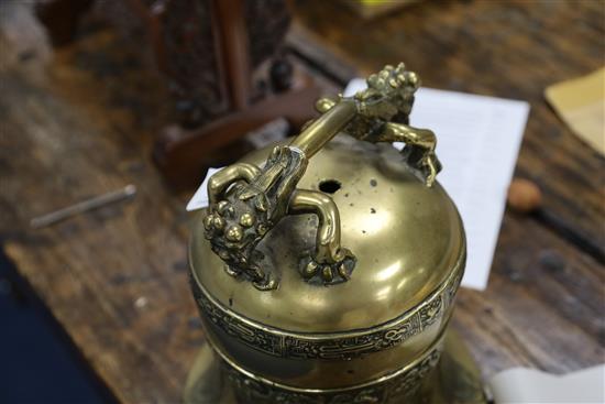 A Chinese Ming bronze bell, 16th/17th century, Height including later wooden dragon stand 73cm